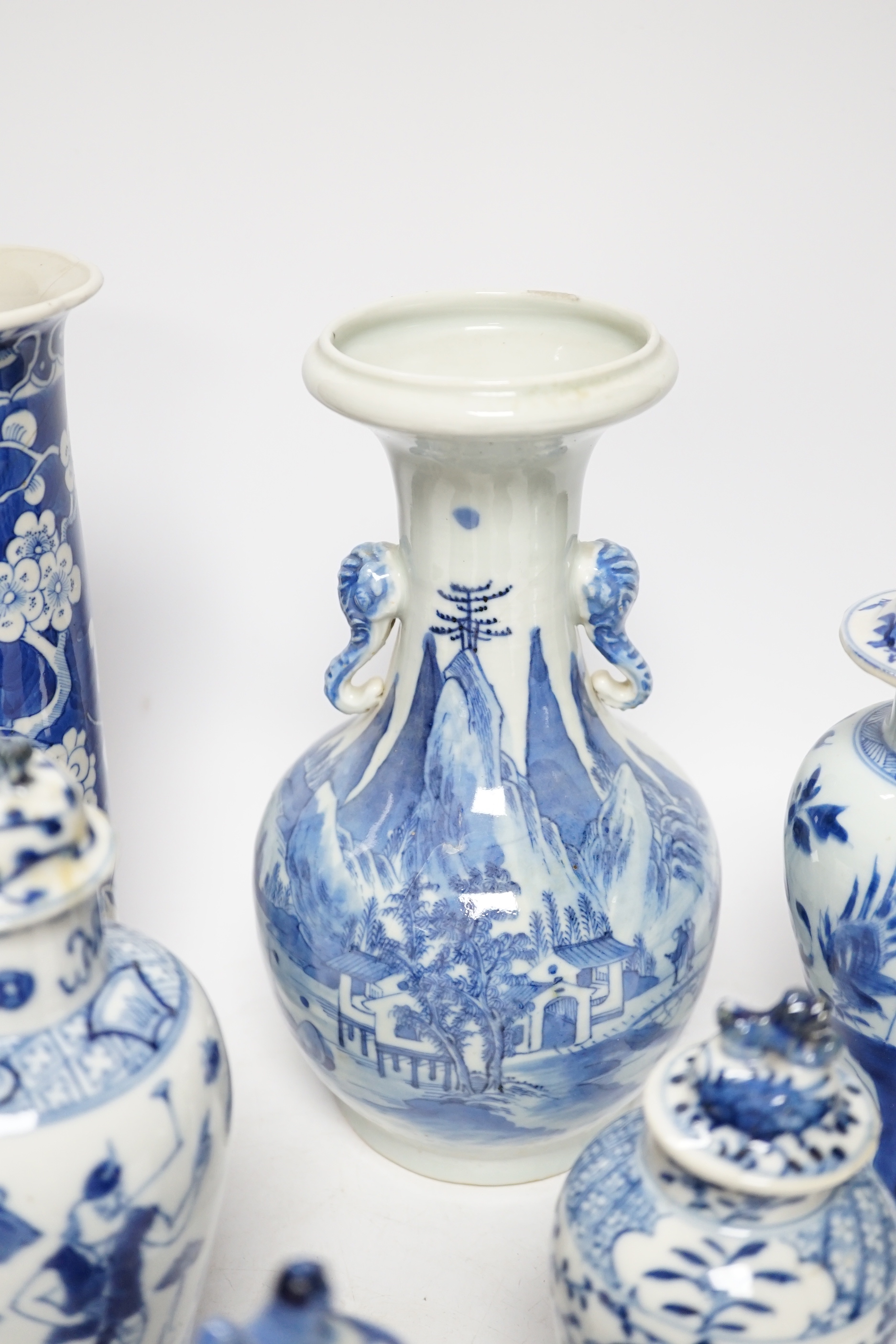 A late 19th century Chinese blue and white twin elephant head handle vase and five other 19th century Chinese blue and white vases, tallest 26cm